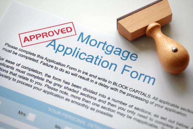 Approved Mortgage loan application with rubber stamp